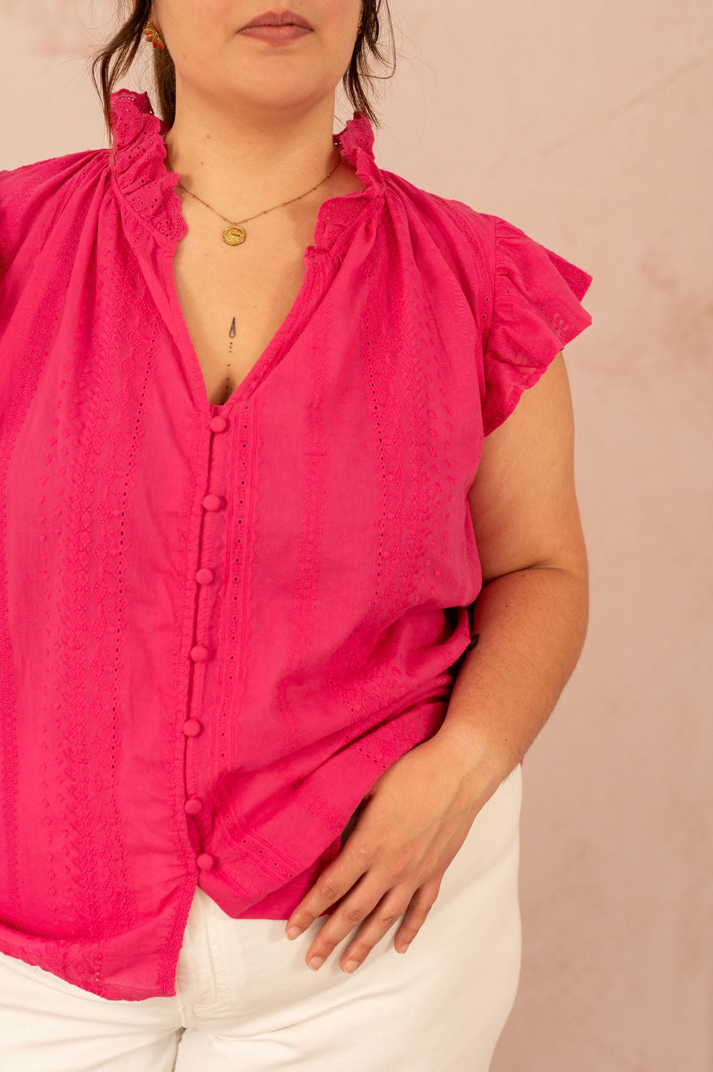 Gros plan sur la blouse Alizée montrant les détails de broderie et les boutons recouverts.