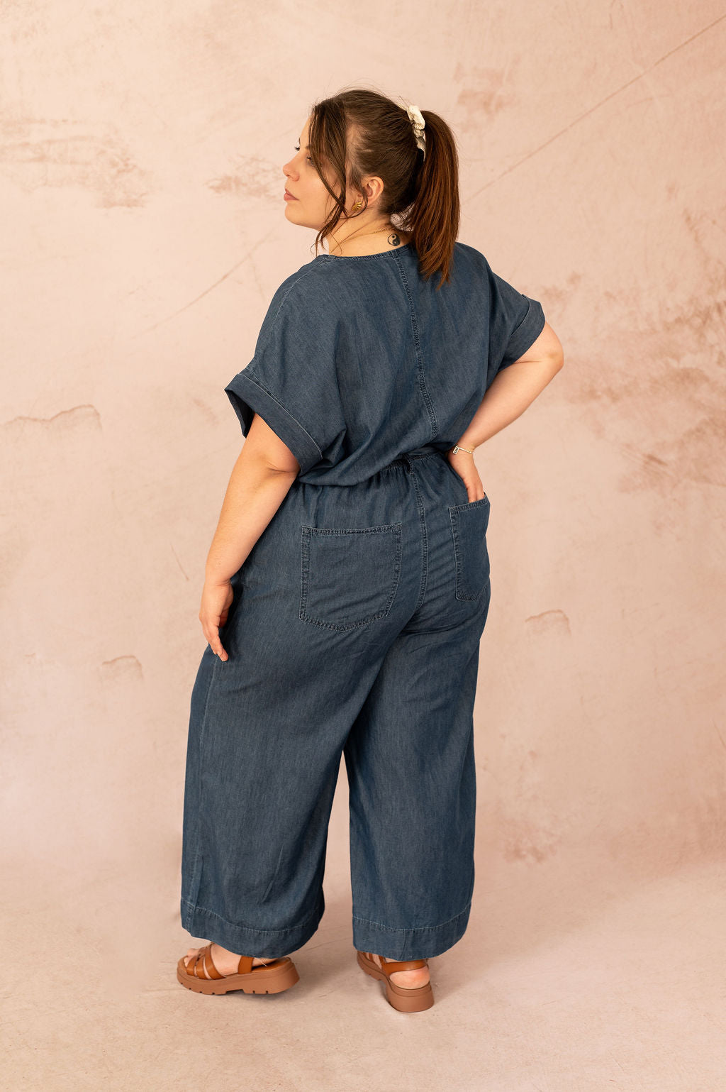 Vue de dos d’une combinaison fluide grande taille en denim avec poches plaquées