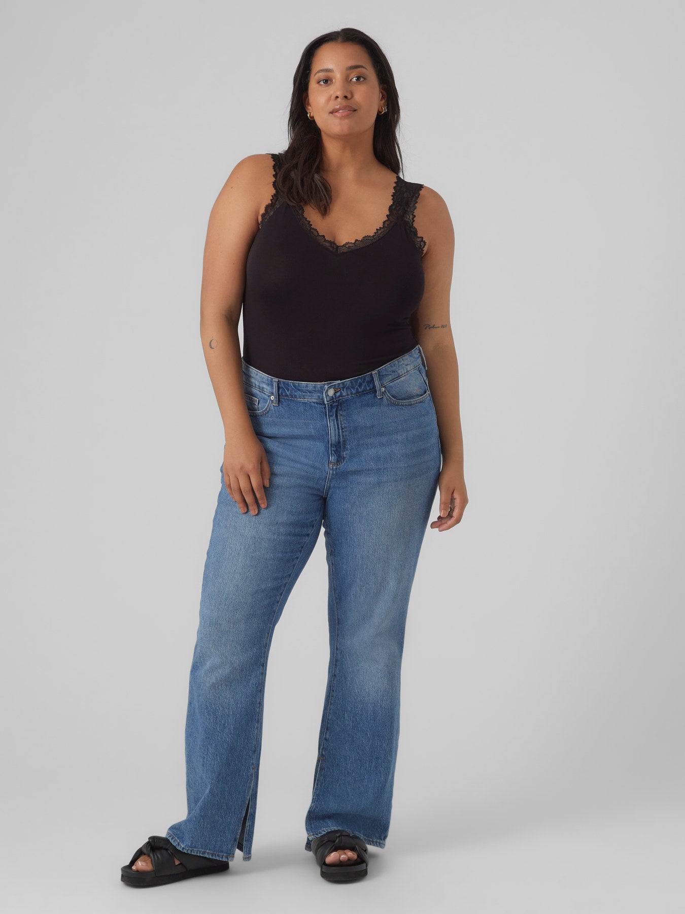 Débardeur noir dentelle et jean, mannequin grande taille en plein pied