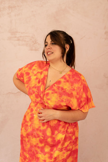 Zoom sur le décolleté croisé de la robe Ciana imprimée orange et rose